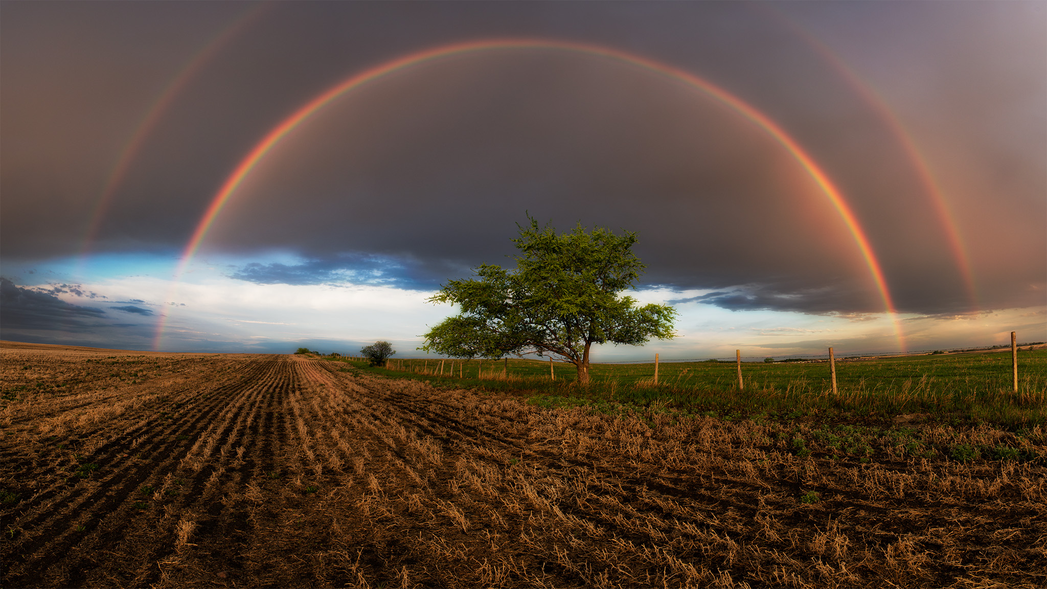 A nature photograph of a double rainbow in Saskatchewan