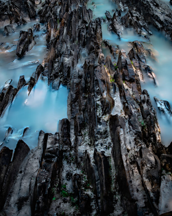 An abstract photograph of a rocky ridge in a glacial river