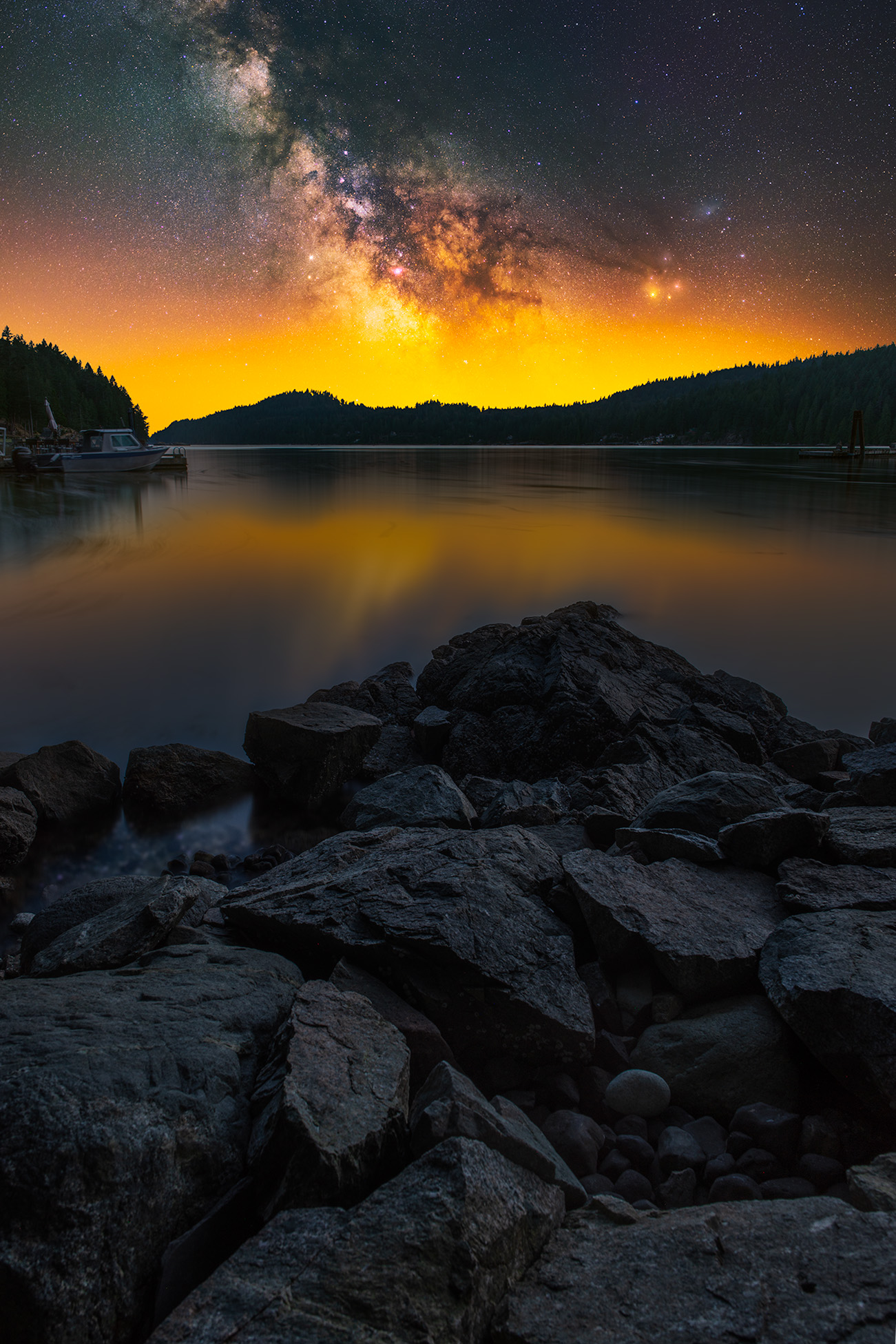 Landscape astrophotography in British Columbia on Gambier Island. The milky way rises above the ocean coastline