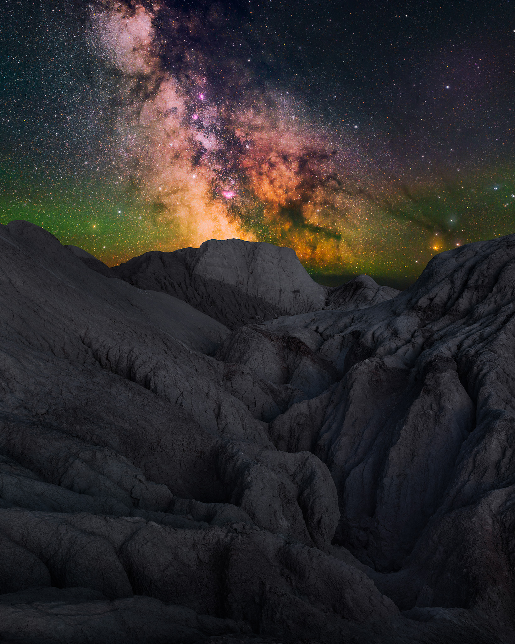 Landscape astrophotography during a night photography workshop in Claybank Saskatchewan. The milky way over clay formations