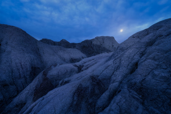 Night and Landscape Photography of a full moon over Saskatchewan badlands near Claybank.