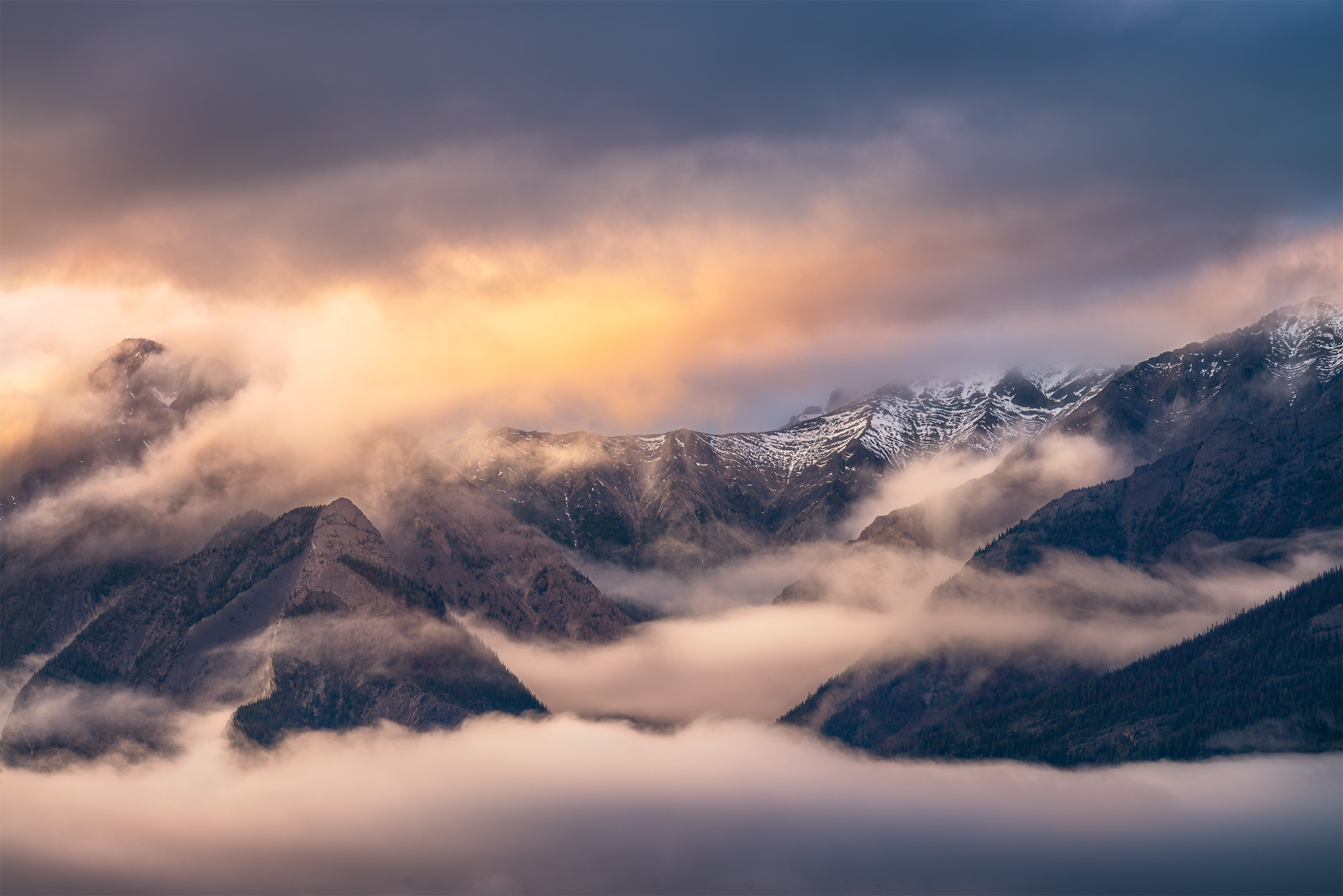 Landscape Photography of dramatic sunset light hitting mountain peaks in the Canadian Rockies in Jasper National Park, Alberta