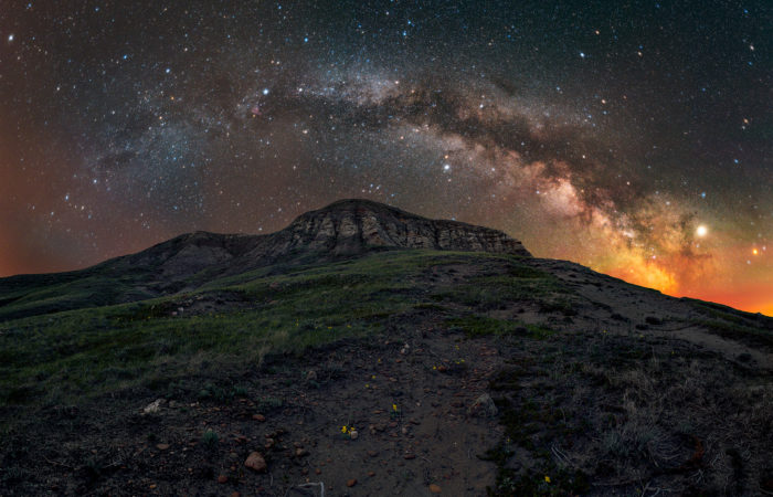 Landscape astrophotography of the summer milky way in a 180 degree panorama of Eagle Butte in Grasslands National Park during a night photography workshop