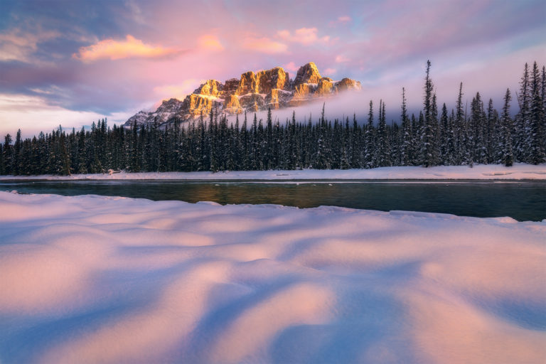 A landscape photograph of a beautiful sunrise at Castle Mountain in the winter