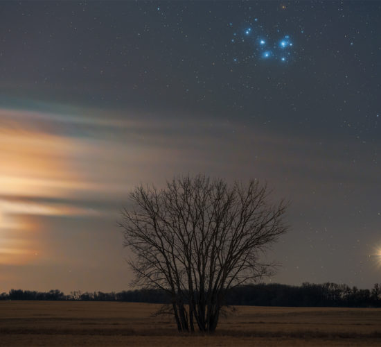 An astrophoto of the conjunction of the moon, Venus, and the Pleiades over the Saskatchewan landscape
