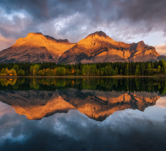 A landscape photograph taken during sunrise at Wedge Pond in the Canadian Rockies