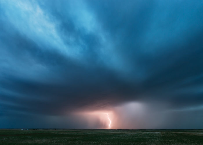 Storm photography of a supercell thunderstorm on the Canadian Prairies with a lightning bolt