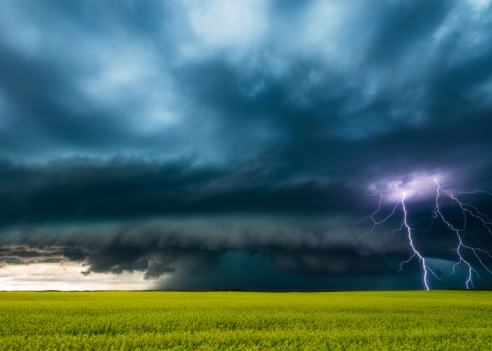 Storm photography of a supercell thunderstorm on the Canadian Prairies with two lightning bolts