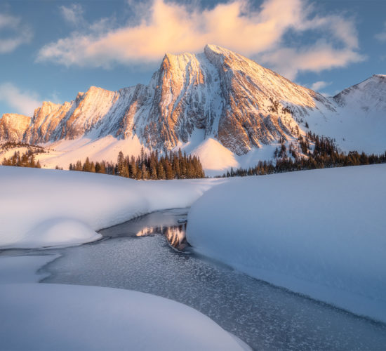 A landscape photograph of Mount Chester in the Canadian Rockies during a winter sunset