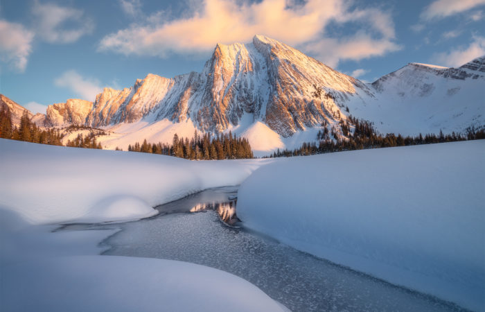 A landscape photograph of Mount Chester in the Canadian Rockies during a winter sunset