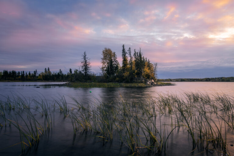 A sunset photograph of the island in front of Holy Trinity Anglican Church
