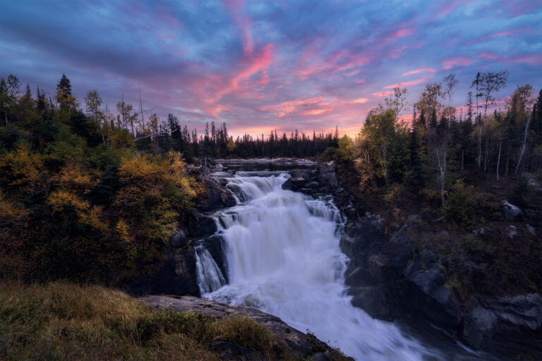 A sunset photograph of Nistowiak Falls in northern Saskatchewan