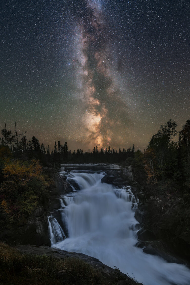 A vertical version of the night photograph of the milky way over Nistowiak Falls in north Saskatchewan