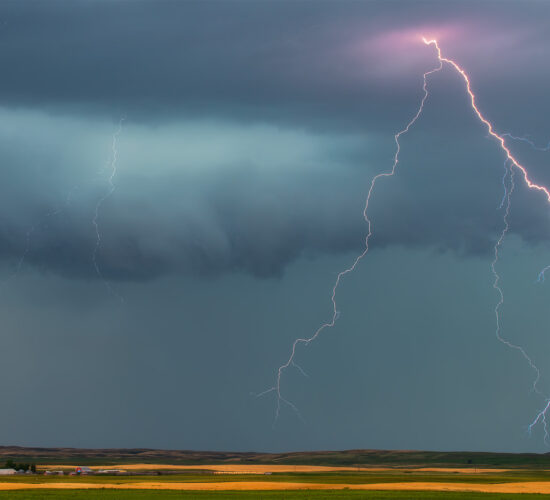 A close up of a lightning strike and an alberta farm