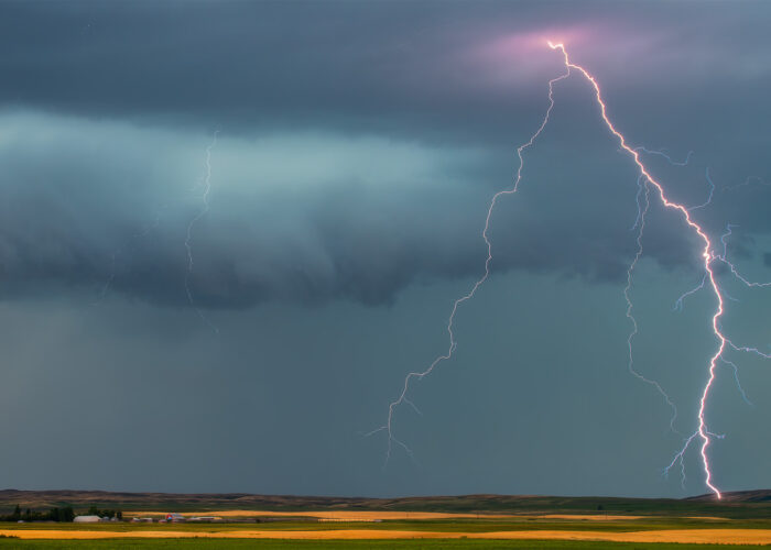 A close up of a lightning strike and an alberta farm