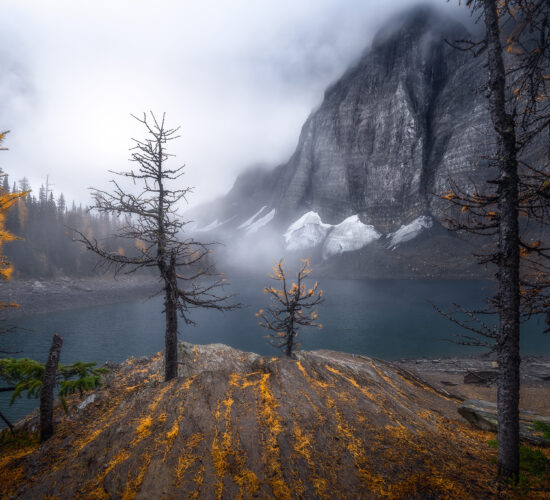 A landscape photograph of Floe Lake in Kootenay National Park on a foggy morning